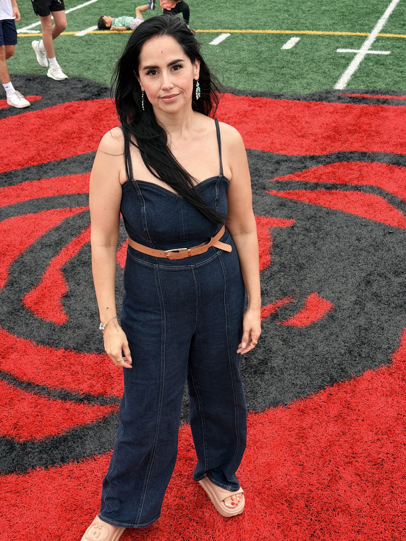 Dra. Perez standing on a football field