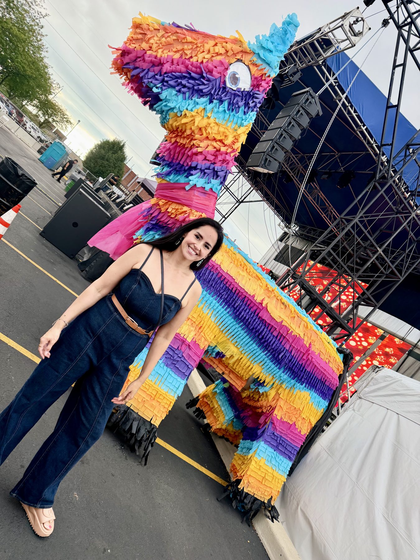 Dra. Perez next to a giant rainbow piñata